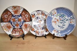 A Japanese porcelain charger decorated with tree in full blossom and blue and white geometrical