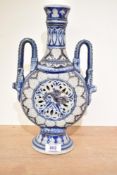 A German Rhenish pottery moon flask, of typical form with bands of repeating motifs, central pierced