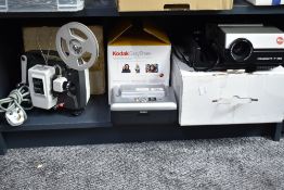 A Kodak EasyShare printer dock, a Plus-O-Matic Super 8 film projector and a Leica PRADOVIT P150