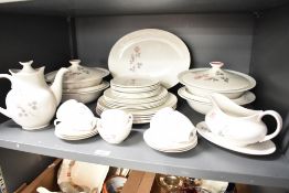 A Royal Doulton Pillar Rose pattern dinner service decorated with floral patterns on a ice white