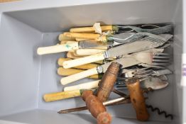 Three wooden handled cork screws and a selection of plastic and bone handled fish cutlery.