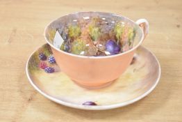 A Royal Worcester cup and saucer, hand painted with fallen fruit, signed 'Freeman', makers mark to