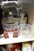 A selection of cut glass items comprising decanter, mantel clock and bowls of various sizes etc.