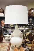 A decorative white glass bulbous form two tier lamp, measuring 66cm tall, shade included.
