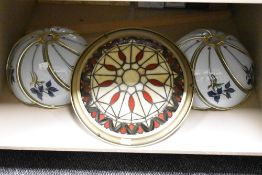 A group of three light fittings, one in the Tiffany style.