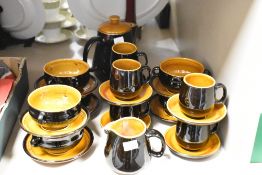 A vintage Prinknash ceramic tea service in dark brown and orange finish, comprising twenty five