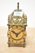 A Smiths brass mechanical lantern clock, having a domed bell top with engraved circular dial and