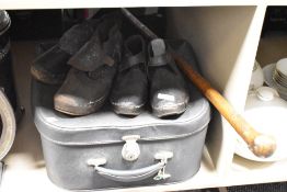 A pair of early 20th century leather clogs, sold together with a suit case, (3)