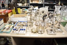 A large selection of silver plated ware to include candlesticks, teapot sold alongside an assortment