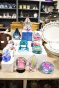 A group of fourteen Caithness paperweights in varied colourways and sizes, majority boxed.