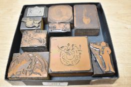 A group of vintage printing blocks, subject matters include Spanish waiter, country landscape