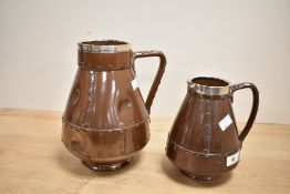A Silicon Lambeth pottery jug having silver rim, shaped handle and riveted style decoration,