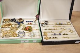 Two faux crocodile jewellery boxes, containing costume jewellery including stud earrings, pendants
