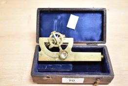 A brass level and clinometer with original case, stamped to side J.Motion & Co, Singapore, L10cm
