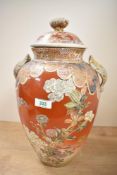 A large Japanese Satsuma pottery vase with cover having figural finale, decorated with flowers,