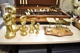 A vintage brass post office scale set complete with weights sold alongside a set of eight brass