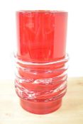 A large red glass vase of cylindrical form, decorated with clear glass swirl design, h31cm