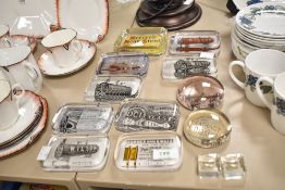 A group of eleven vintage advertising glass paperweights to include Bommer Spring Hinges, William