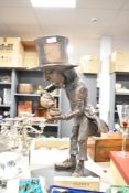 A large resin sculptural outdoor water feature depicting Alice in Wonderland's Mad Hatter on base,