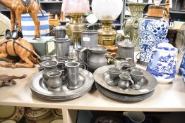 A large assortment of pewter ware and similar to include steins, egg cups and plates etc.