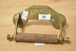 A 20th century brass toilet roll holder, w16.5cm