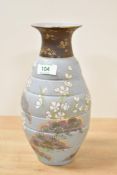 A Doulton & Slaters pottery vase hand painted with floral patterns on a blue ground, h25cm