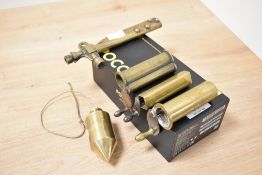 A 20th century brass plumb bob, h8cm, sold together with detonator key ect, (5)