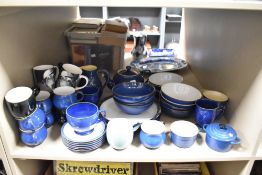 A selection of Denby pottery and similar the majority in a navy blue glaze finish, including mugs,