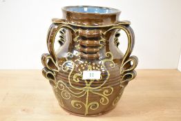 An attractive 1970's slipware pottery vessel, of baluster form with three applied handles