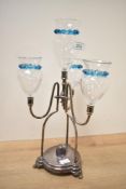 An unusual and attractive silver plate and glass epergne, the central 'vase' within three shaped