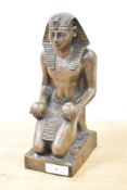 A figure of an Egyptian faro having impressed symbols to back, h23.5cm