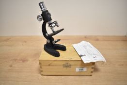 A small Skybolt students microscope 100x, 200x and 300x magnification, sold with pine box and
