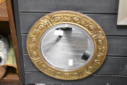 An early 20th century circular wall mirror having bevelled edge glass, w36cm