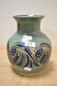 A Langrigg studio pottery vase, having a flared rim over a short neck and globular body decorated