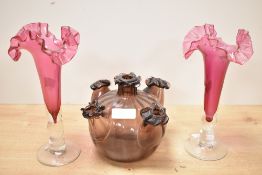 A pair of cranberry glass vases having bobbin stem and frilled edges, h21cm, sold together with