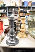 An assortment of various wooden candlesticks, comprising seventeen approximately.