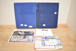 A pair of Stanley Gibbons' expanding stamp albums including a varied range of stamps, viewing