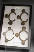 A display case holding four tribal bangles, h31cm
