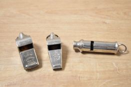 A group of three vintage whistles, two marked for 'The Acme Thunderer'.