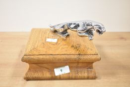 A Jaguar car mascot raised on an oak base, h14.5cm