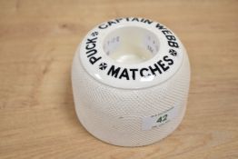 A 20th century Captain Webb advertising match striker, h7cm