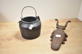 A vintage cast metal door stop in the form of a beetle sold together with a small cast iron cauldron
