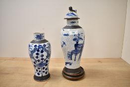 An early 20th century Chinese blue and white vase with cover decorated with scenes of figures and