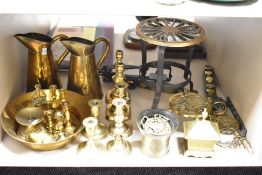 A large selection of brass ware and similar to include various candlesticks, jugs and kettle stand