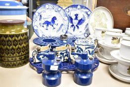 A pair of hand-painted blue and white plates sold alongside and two cast iron navy blue food warmers
