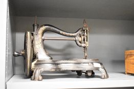 A Victorian patent hand sewing machine, of shaped form with hand-cranked mechanism, 38cm long