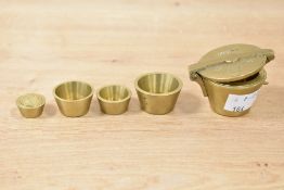 A set of solid brass nesting weights having impressed eagle mark and No '1856', h3cm