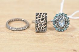 Three white metal rings, comprising a white sapphire full eternity band, a paste and marcasite set
