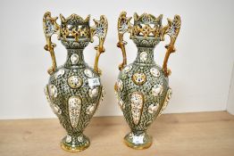 A pair of late 19th century Majolica style vases having scroll style handles and pierced top,