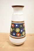 A 20th century German ceramic vase of baluster form, decorated with floral designs, impressed